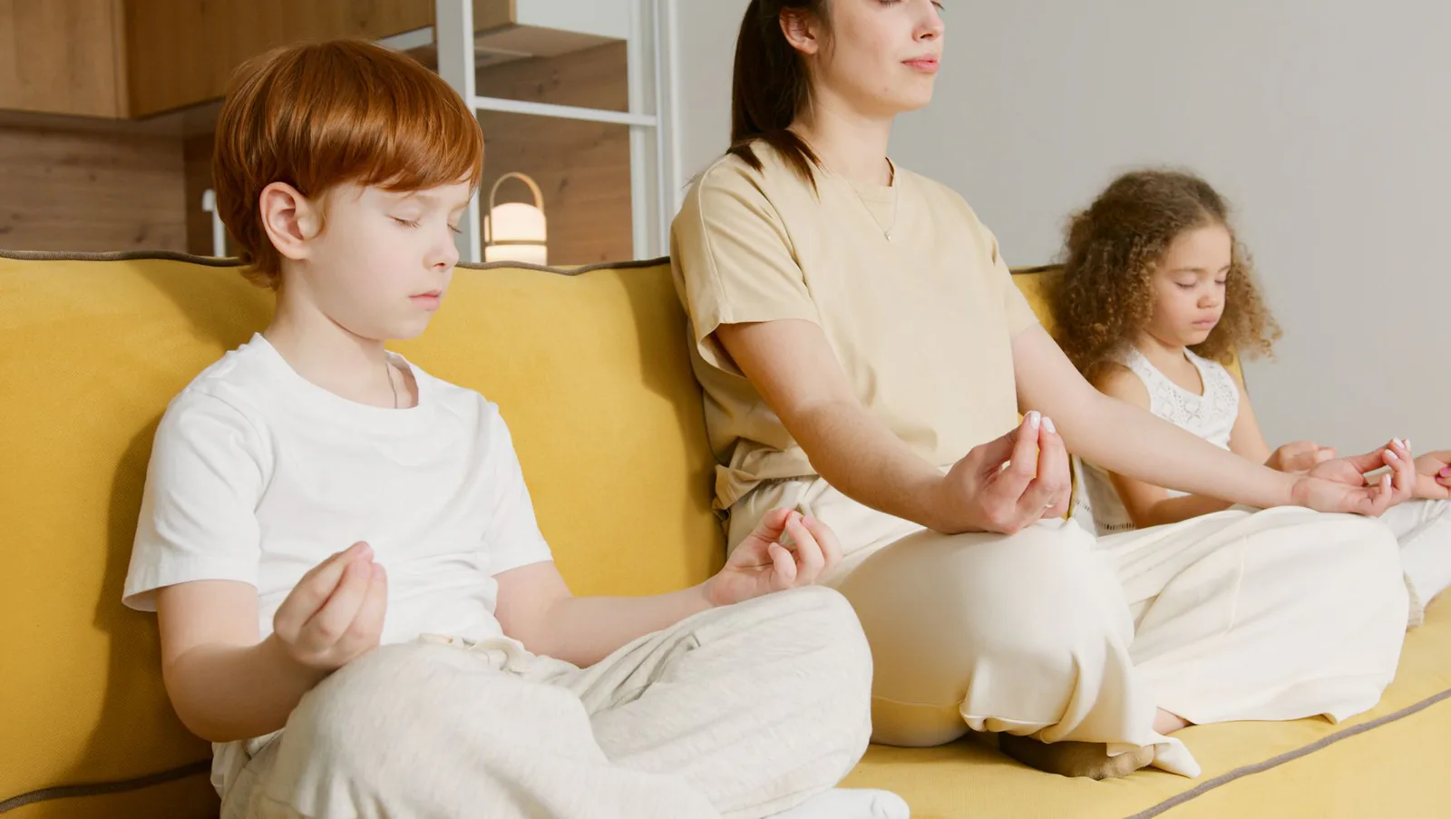Family practicing meditation together at home