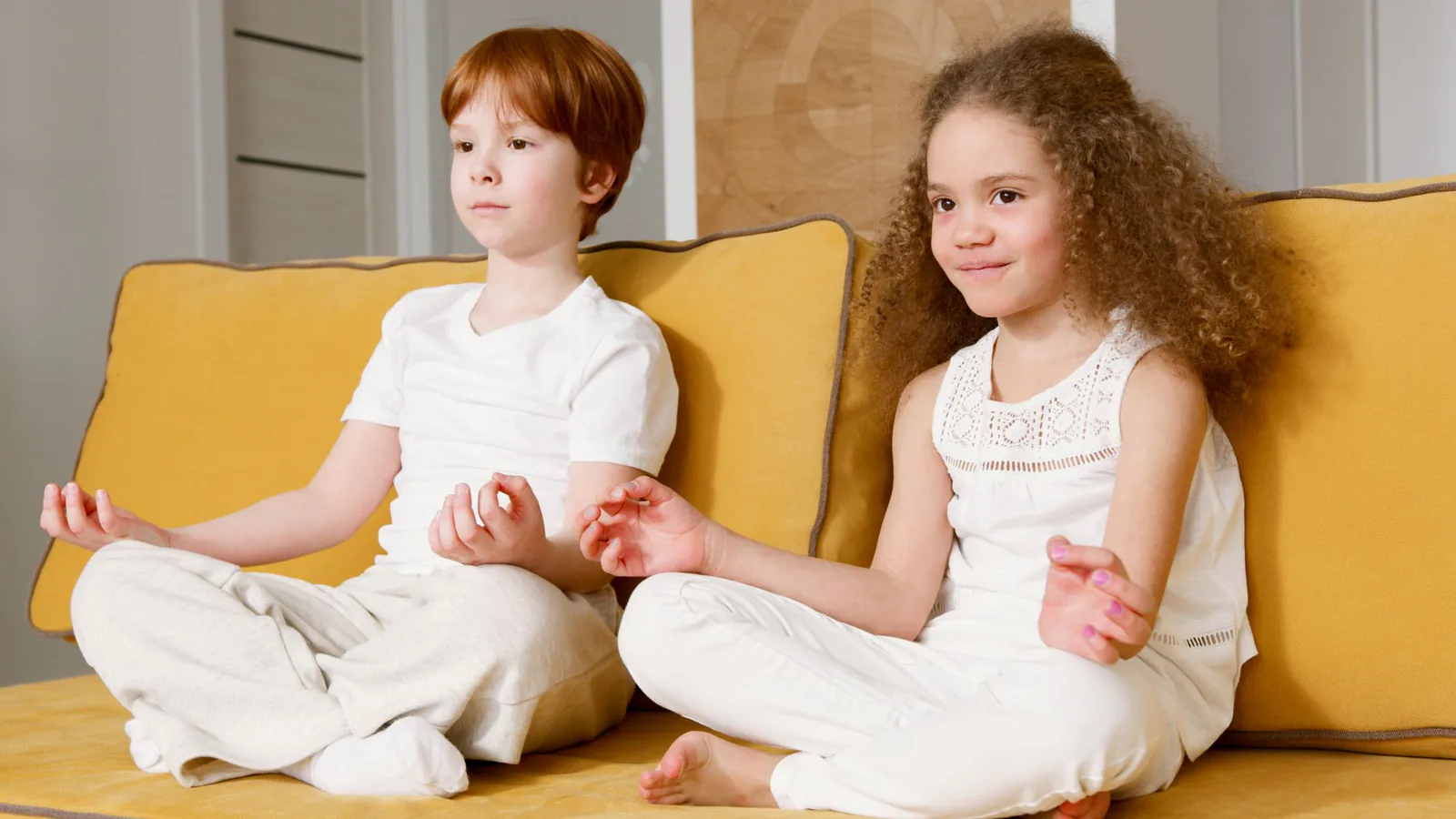 A child sitting calmly in a yoga pose
