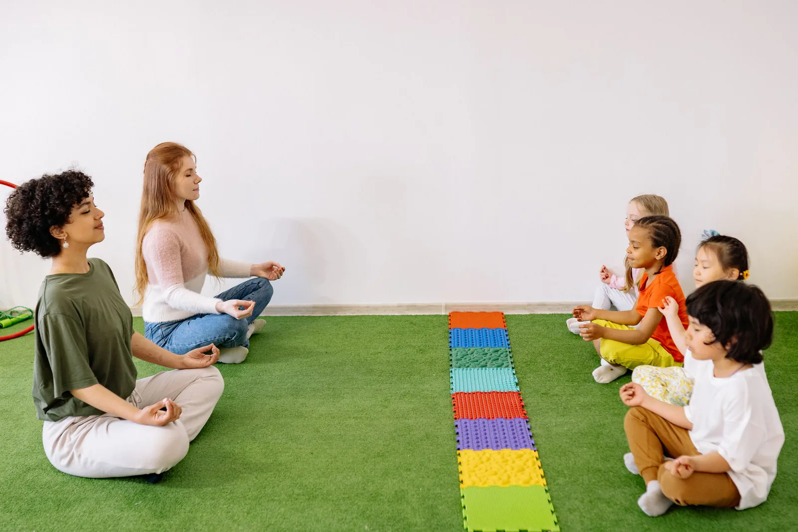 Children and teachers in a preschool yoga and mindfulness session
